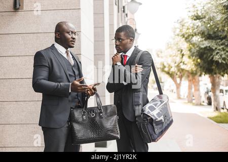 Portrait of two black African American businessman in suits outdoors. Stock Photo