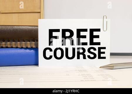 FREE ONLINE COURSE, message on the card shown by a man, vintage tone. Stock Photo