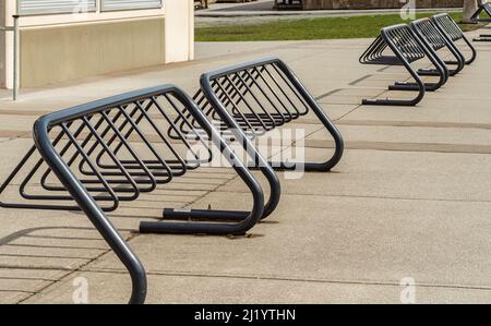 Modern bicycle rack on the street of a city. Nobody, selective focus, street photo Stock Photo