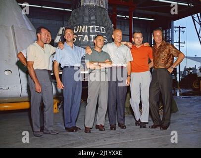 The Mercury Seven astrobauts in front of the Mercuy capsule. They are From left to right: Gordon Cooper, Walter Schirra, Alan Shepard, Virgil Grissom, John Glenn, Donald Slayton and Scott Carpenter. Stock Photo