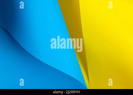 Blue and yellow paper is curved by a wavy line. Background of shape and curve line. Abstract creative design. Stock Photo