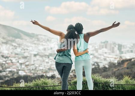 Feel free to be you. Shot of two unrecognizable woman enjoying the view on a mountain after a run. Stock Photo