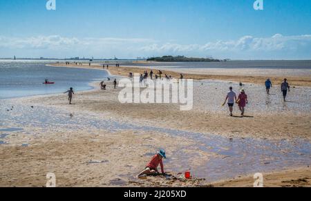 low tide sand causeway between the Wellington Point and King Island against the backdrop of Port of Brisbane on Fisherman Islands, Southern Moreton Ba Stock Photo