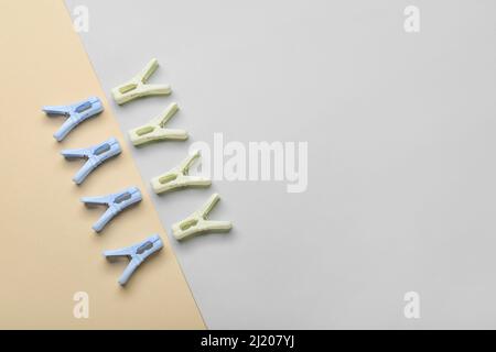 Plastic clothes pins on light background Stock Photo