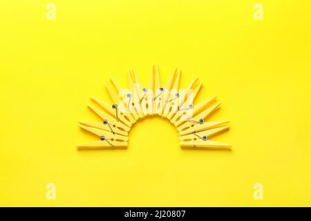 Plastic clothes pins on color background Stock Photo