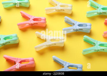 Plastic clothes pins on color background Stock Photo