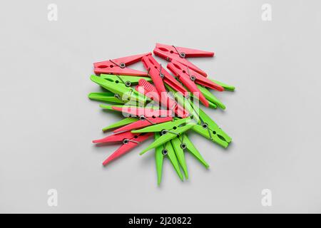 Plastic clothes pins on grey background Stock Photo
