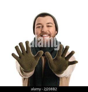 Young bearded man in warm gloves, hat and scarf on white background Stock Photo