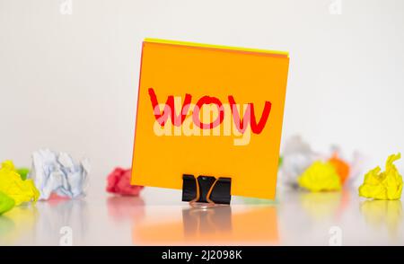 Creative word wow on multicolored stickers against the background of a cork board Stock Photo