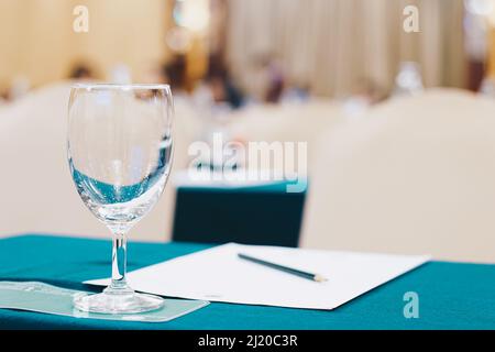 Drinkking water in wine glass on table of meeting room blurred background Stock Photo