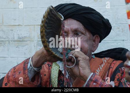 March 27, 2022, Lahore, Punjab, Pakistan: Pakistani devotees and Malangs attend the three-days 434th annual Urs 'Festival of lights' at the shrine of Muslim Sufi saint Shah Hussain, popularly known as Madho Lal Hussain in Lahore. The annual 3 days festival was held at Madhu Lal's shrine on his 434th birth anniversary. Mela Charaghan has its own importance in Lahore's history, as it has been a biggest festival of Lahore in some times.The festival was started with the seasonal Baisakhi festival in old times. Foolproof security arrangements have been made for the devotees. The last day of the Urs Stock Photo