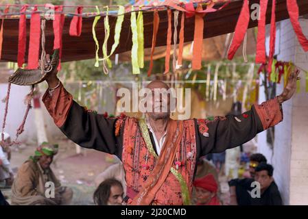 March 27, 2022, Lahore, Punjab, Pakistan: Pakistani devotees and Malangs attend the three-days 434th annual Urs 'Festival of lights' at the shrine of Muslim Sufi saint Shah Hussain, popularly known as Madho Lal Hussain in Lahore. The annual 3 days festival was held at Madhu Lal's shrine on his 434th birth anniversary. Mela Charaghan has its own importance in Lahore's history, as it has been a biggest festival of Lahore in some times.The festival was started with the seasonal Baisakhi festival in old times. Foolproof security arrangements have been made for the devotees. The last day of the Urs Stock Photo