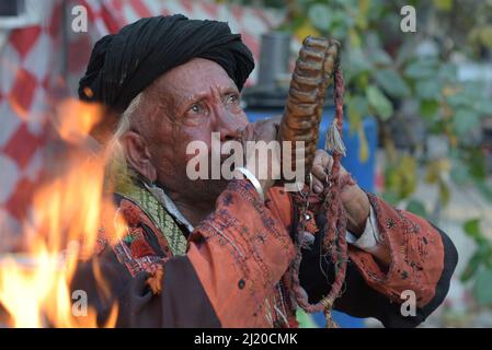 March 27, 2022, Lahore, Punjab, Pakistan: Pakistani devotees and Malangs attend the three-days 434th annual Urs 'Festival of lights' at the shrine of Muslim Sufi saint Shah Hussain, popularly known as Madho Lal Hussain in Lahore. The annual 3 days festival was held at Madhu Lal's shrine on his 434th birth anniversary. Mela Charaghan has its own importance in Lahore's history, as it has been a biggest festival of Lahore in some times.The festival was started with the seasonal Baisakhi festival in old times. Foolproof security arrangements have been made for the devotees. The last day of the Urs Stock Photo