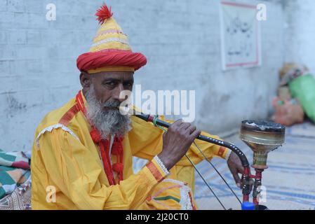 March 27, 2022, Lahore, Punjab, Pakistan: Pakistani devotees and Malangs attend the three-days 434th annual Urs 'Festival of lights' at the shrine of Muslim Sufi saint Shah Hussain, popularly known as Madho Lal Hussain in Lahore. The annual 3 days festival was held at Madhu Lal's shrine on his 434th birth anniversary. Mela Charaghan has its own importance in Lahore's history, as it has been a biggest festival of Lahore in some times.The festival was started with the seasonal Baisakhi festival in old times. Foolproof security arrangements have been made for the devotees. The last day of the Urs Stock Photo