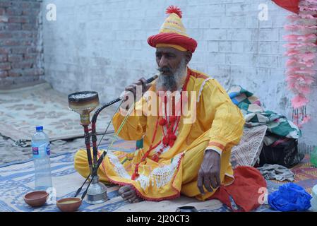 March 27, 2022, Lahore, Punjab, Pakistan: Pakistani devotees and Malangs attend the three-days 434th annual Urs 'Festival of lights' at the shrine of Muslim Sufi saint Shah Hussain, popularly known as Madho Lal Hussain in Lahore. The annual 3 days festival was held at Madhu Lal's shrine on his 434th birth anniversary. Mela Charaghan has its own importance in Lahore's history, as it has been a biggest festival of Lahore in some times.The festival was started with the seasonal Baisakhi festival in old times. Foolproof security arrangements have been made for the devotees. The last day of the Urs Stock Photo