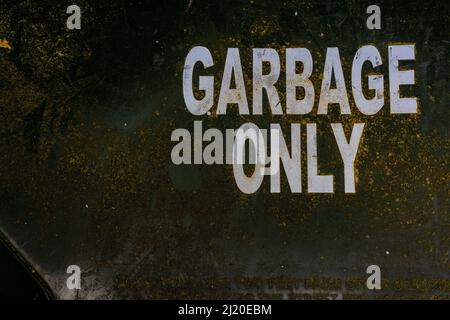 Garbage only sign/text on top of trash can. Perfect texture for grunge environment. Stock Photo