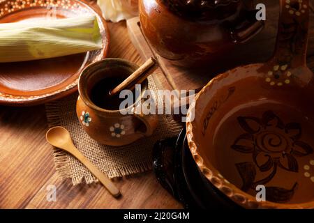 https://l450v.alamy.com/450v/2j20g4m/authentic-homemade-mexican-coffee-cafe-de-olla-served-in-traditional-clay-mug-jarrito-de-barro-on-rustic-wooden-table-2j20g4m.jpg