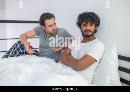 Displeased guy arguing with his male partner Stock Photo