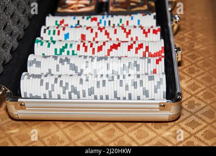 Poker chips lined up in a case with shallow depth of field Stock Photo