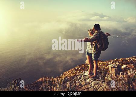 Lets fly away together. a young couple enjoying a day at the beach ...