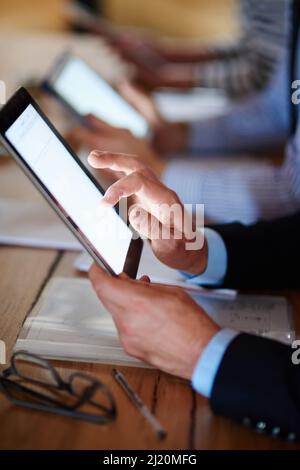 The very meaning of byod. Closeup shot of businesspeople using digital tablets during a conference. Stock Photo