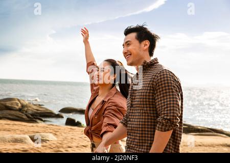 Young couple strolling on the beach - stock photo Stock Photo