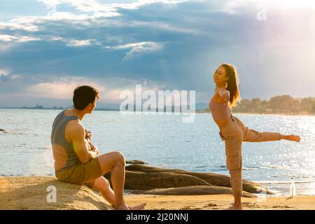 Newlyweds enjoying their honeymoon at the beach under the summer sun  - stock photo Stock Photo