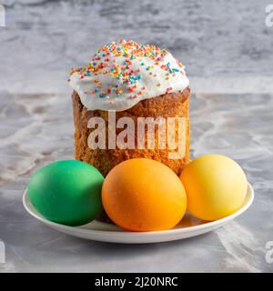 Easter cake and colorful Easter eggs on the plate. Traditional orthodox christian easter food. Stock Photo
