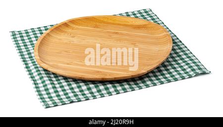 Wooden plate and tablecloth on white background Stock Photo