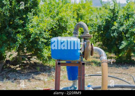 water pump used to irrigate the orchard. Selective Focus Stock Photo