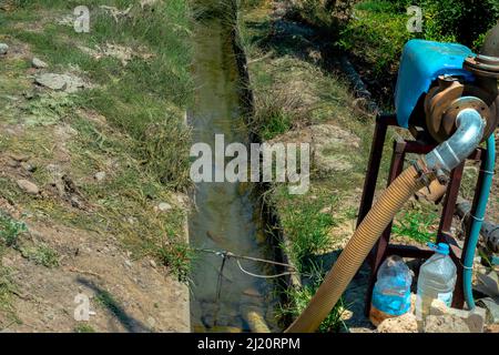 water pump used to irrigate the orchard. Selective Focus Stock Photo