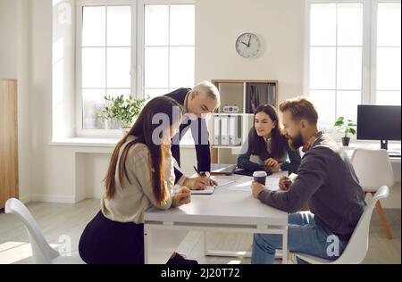 Diverse colleagues brainstorm over business project together Stock Photo