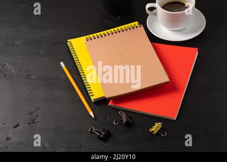 Three notepads on a black table close up Stock Photo