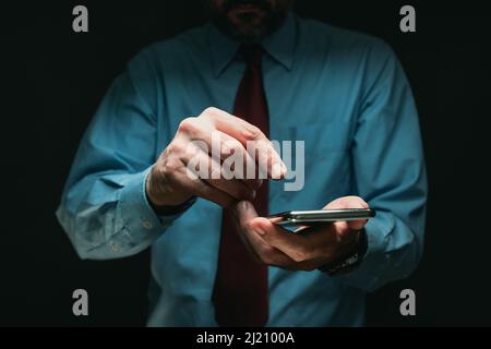 Mobile phone business communication, businessman tapping smartphone screen, selective focus Stock Photo