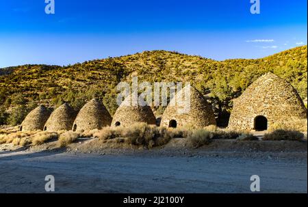 This is a view of six of the ten beehive-shaped Wildrose Charcoal Kilns in Wildrose Canyon of Death Valley National Park, California, USA. Stock Photo