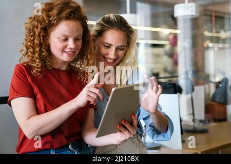 Happy successful young business colleagues working in office. Business people technology concept Stock Photo