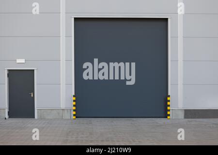 Roller door or roller shutter using for factory, warehouse or hangar. Outdoors Stock Photo