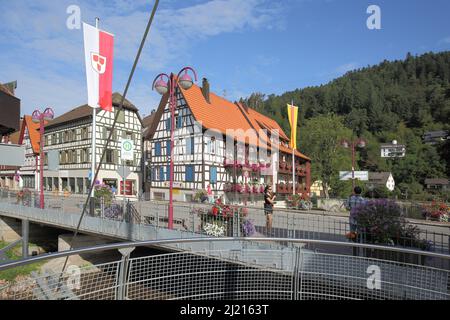 Half-timbered houses and city flag in the main street in Schiltach, Baden-Württemberg, Germany Stock Photo