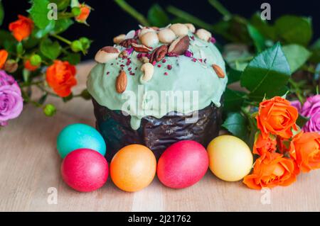 delicious Easter cake with pistachio cream with colored eggs for the religious holiday of Easter in spring in April Stock Photo