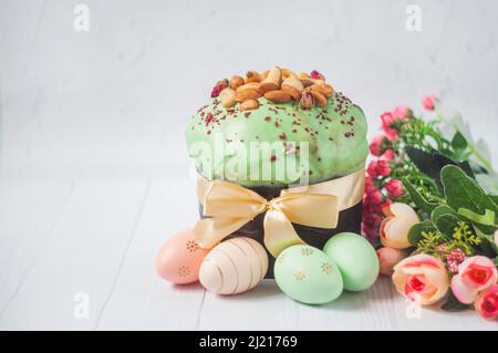 delicious Easter cake with pistachio cream with colored eggs for the religious holiday of Easter in spring in April Stock Photo