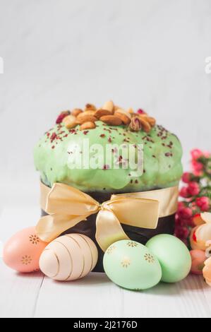 delicious Easter cake with pistachio cream with colored eggs for the religious holiday of Easter in spring in April Stock Photo