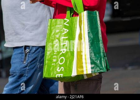 Waitrose and Partners green 100% recycled plastic reusable eco-Shopping Bags for Life, Preston, Lancashire, UK Stock Photo