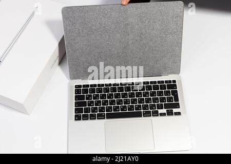 Saratov, Russia - February 26, 2022: translucent protective film on new silver Macbook Air 13 inch with M1 processor topview, white background Stock Photo
