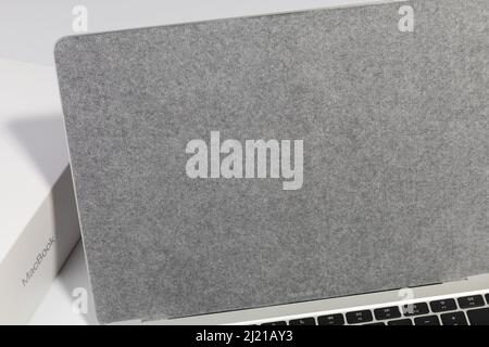 Saratov, Russia - February 26, 2022: screen of Macbook Air 13 inch with M1 processor covered with protective film closeup, white background Stock Photo