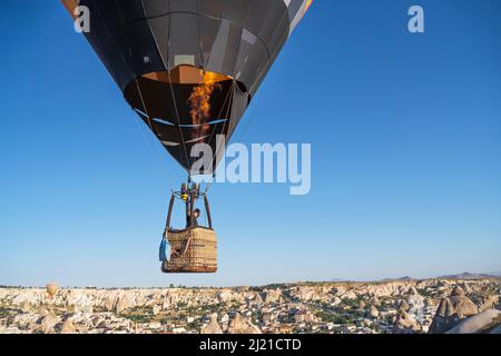 hot air balloon flies low over cities Stock Photo