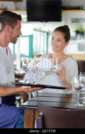 waiters setting a table in a restaurant Stock Photo