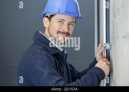 a male builder during window maintenance service Stock Photo