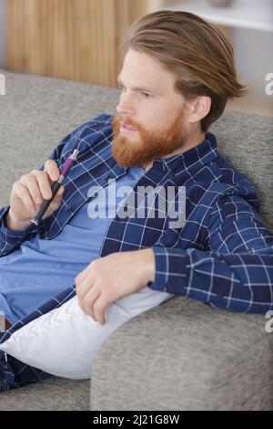 young man using vapourizer as smoking alternative Stock Photo