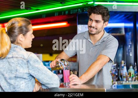 woman ordering from a bartender in a bar Stock Photo
