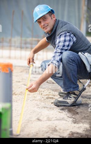 builder working outdoors at construction site Stock Photo